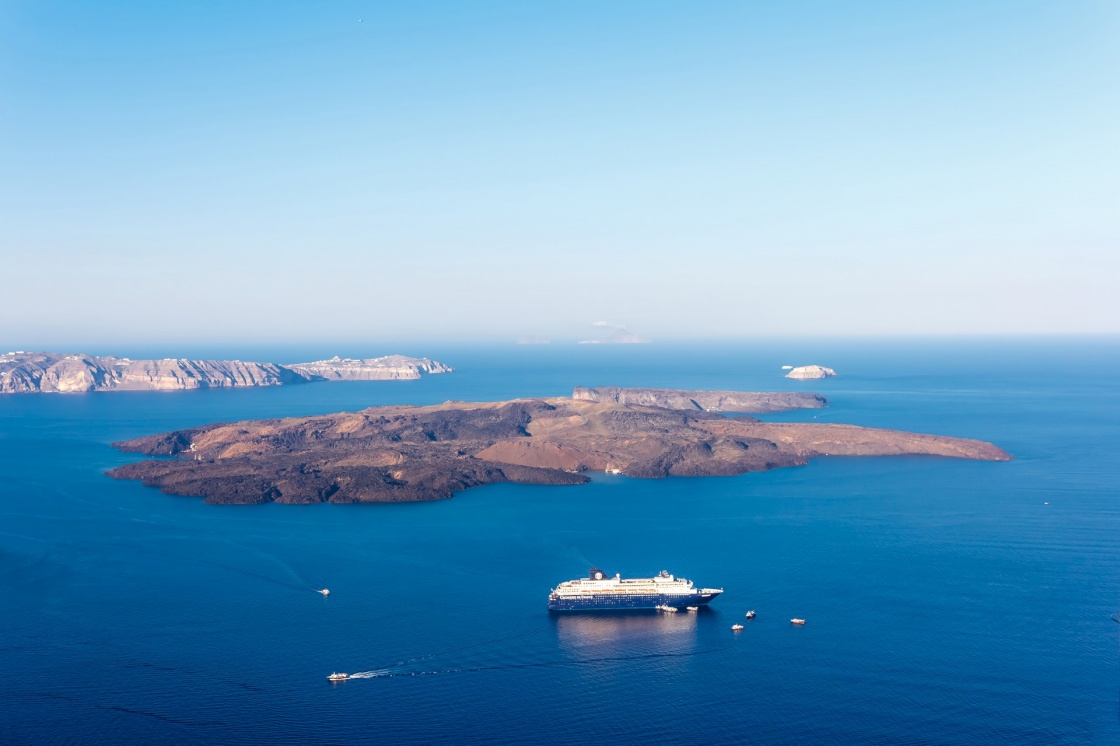 'Nea Kameni volcanic island in Santorini Greece with ships in front photographed from a high point of view' - Santorini